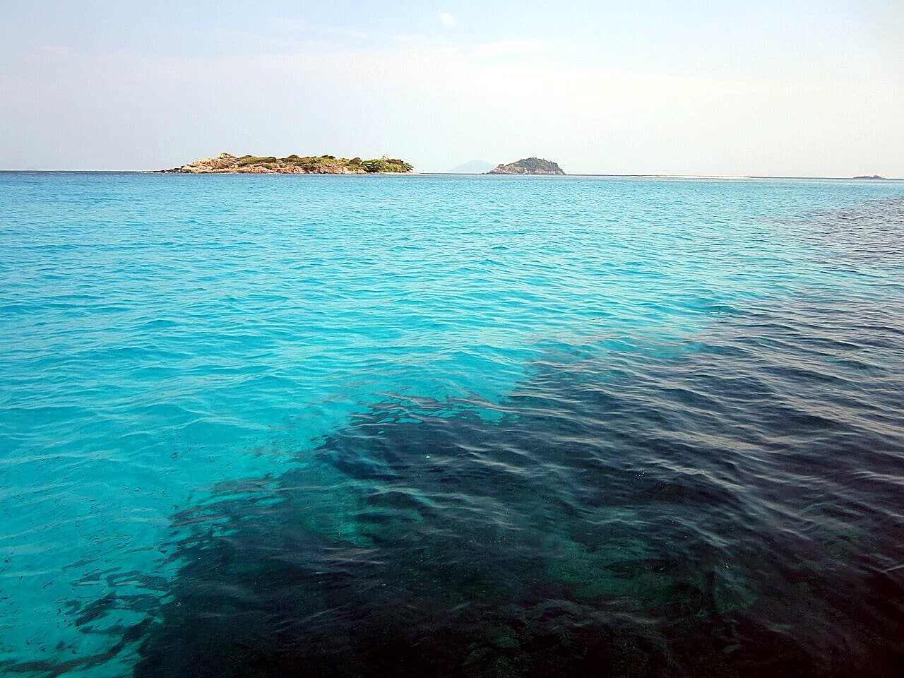 The clear, shallow turquoise water off Long Beach on Pulau Redang, where the free house reef runs