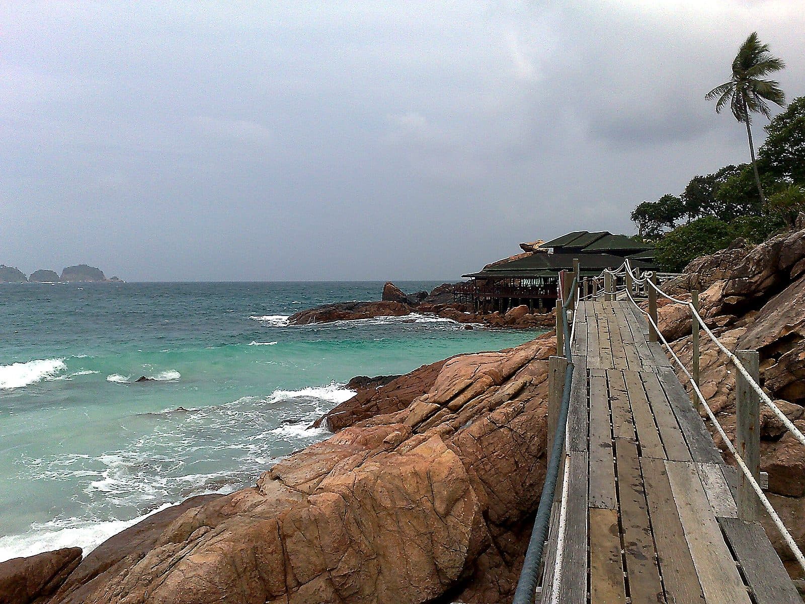 The timber coastal boardwalk at Laguna Redang, running over the rocks above clear water