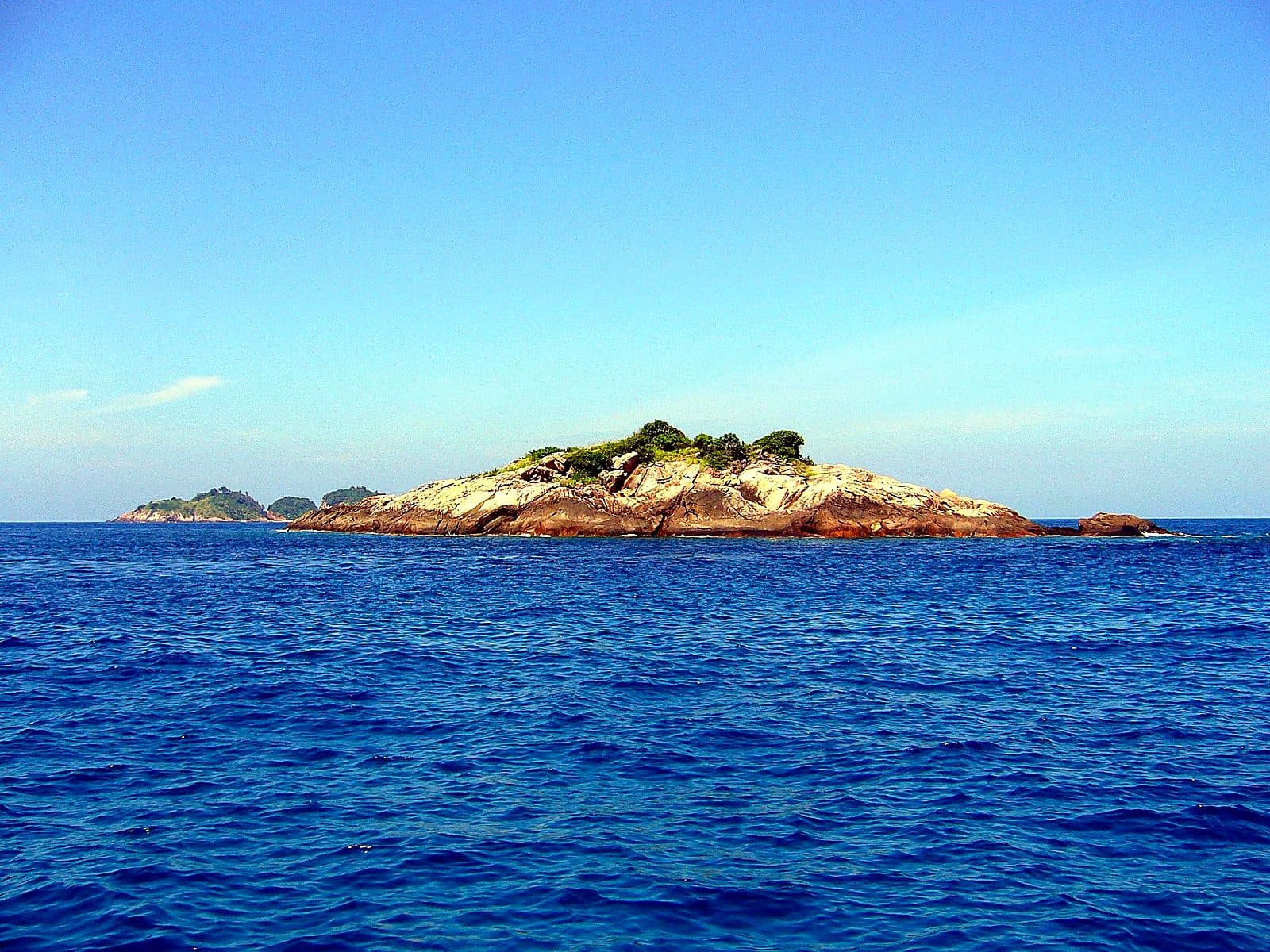 A small green islet off Pulau Redang, ringed by the clear water of the marine park